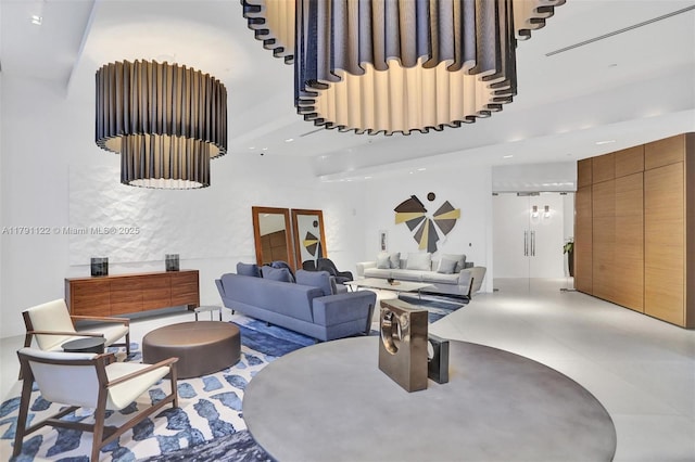 living room featuring recessed lighting, finished concrete flooring, and a towering ceiling