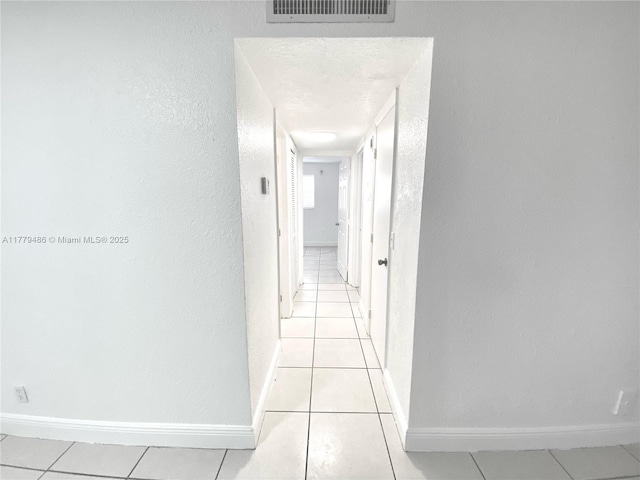 4160 NW 21st St Unit 216-E, Lauderhill, FL 33313 - corridor featuring light tile patterned floors, baseboards, a textured wall, and visible vents