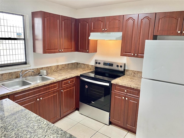 4160 NW 21st St Unit 216-E, Lauderhill, FL 33313 - kitchen featuring stainless steel range with electric cooktop, light tile patterned flooring, a sink, freestanding refrigerator, and under cabinet range hood