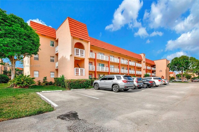 9281 Sunrise Lakes Blvd Unit 306, Sunrise, FL 33322 - view of apartment building / complex featuring uncovered parking