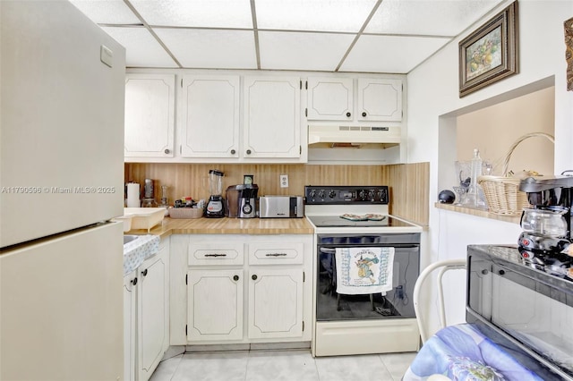 9281 Sunrise Lakes Blvd Unit 306, Sunrise, FL 33322 - kitchen with white appliances, under cabinet range hood, a paneled ceiling, light tile patterned flooring, and light countertops