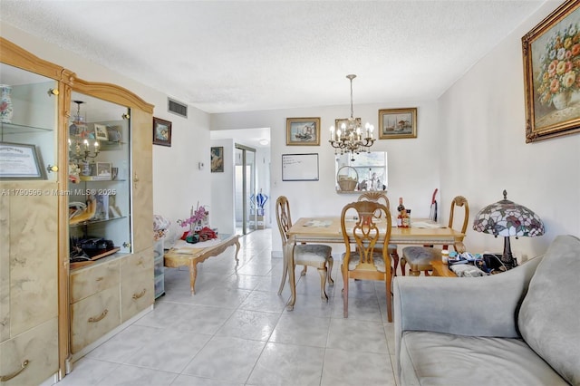 9281 Sunrise Lakes Blvd Unit 306, Sunrise, FL 33322 - dining space featuring a textured ceiling, a chandelier, and light tile patterned floors