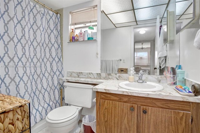 9281 Sunrise Lakes Blvd Unit 306, Sunrise, FL 33322 - bathroom featuring toilet, vanity, and a shower with shower curtain