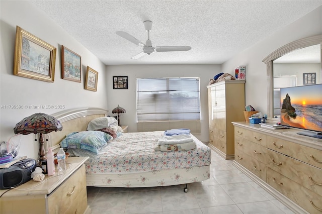 9281 Sunrise Lakes Blvd Unit 306, Sunrise, FL 33322 - bedroom featuring ceiling fan, light tile patterned floors, and a textured ceiling