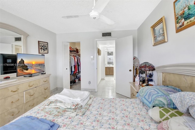 9281 Sunrise Lakes Blvd Unit 306, Sunrise, FL 33322 - bedroom with light tile patterned flooring, a textured ceiling, ceiling fan, a closet, and a spacious closet