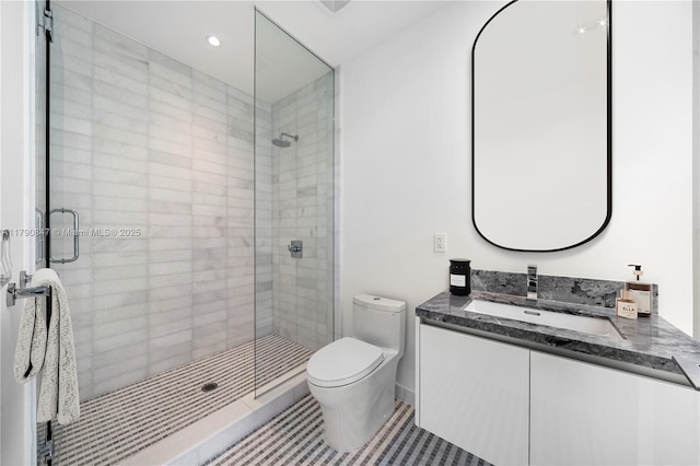 full bath with tile patterned floors, vanity, toilet, and a stall shower