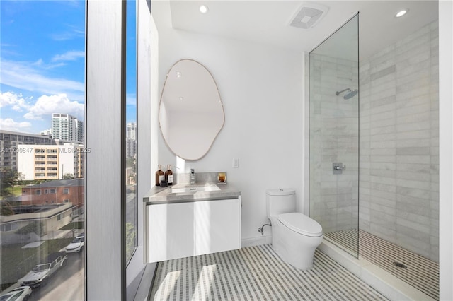 full bath with toilet, recessed lighting, tiled shower, and vanity