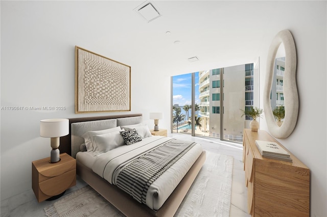 bedroom with a wall of windows, visible vents, and access to outside