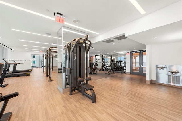 workout area with visible vents, wood finished floors, and french doors