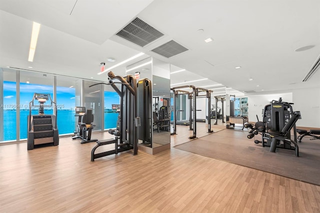 workout area with wood finished floors and visible vents