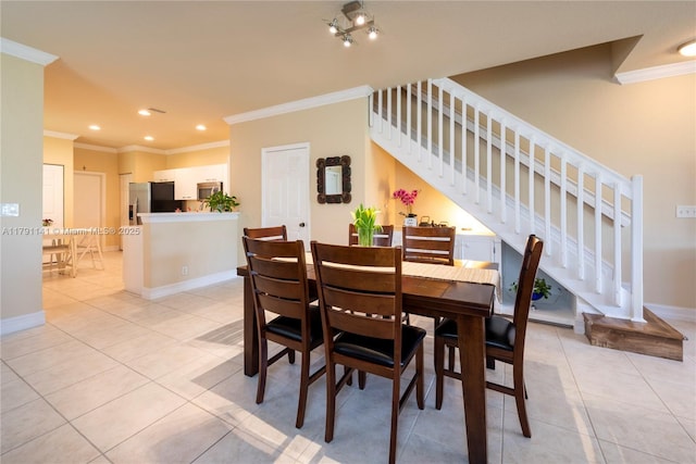 dining room with crown molding, stairs, and light tile patterned flooring