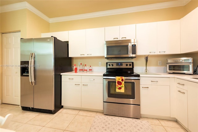kitchen with ornamental molding, appliances with stainless steel finishes, a toaster, and light countertops