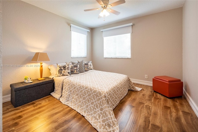 bedroom featuring baseboards, a ceiling fan, and wood finished floors