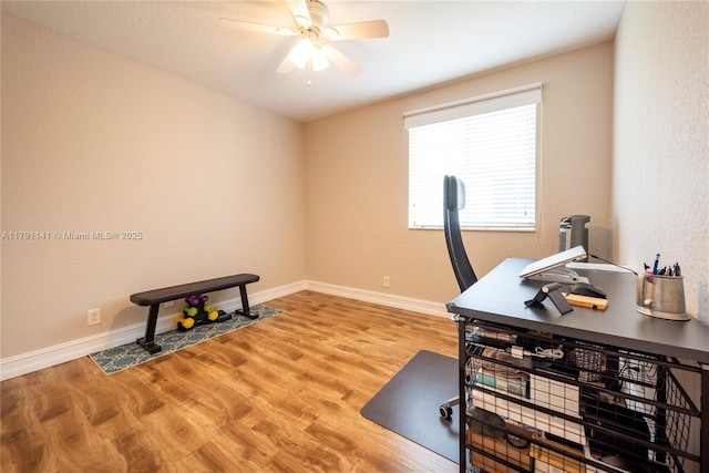 office with baseboards, a ceiling fan, and wood finished floors
