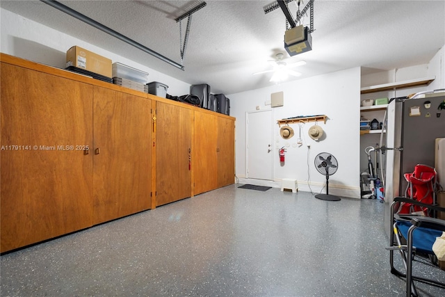 garage featuring freestanding refrigerator, a ceiling fan, and a garage door opener