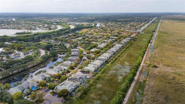 drone / aerial view featuring a water view and a residential view