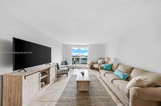 living area featuring light tile patterned floors and a wall of windows