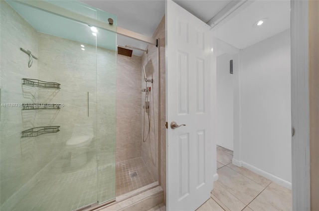 full bathroom featuring tile patterned floors and a shower stall