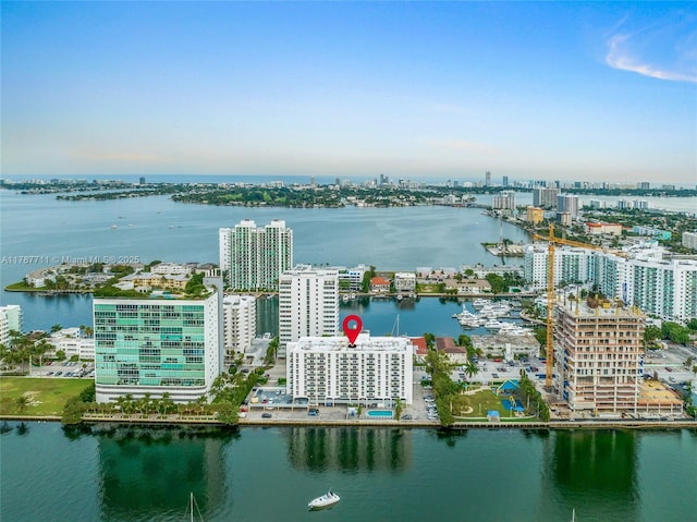birds eye view of property with a view of city and a water view