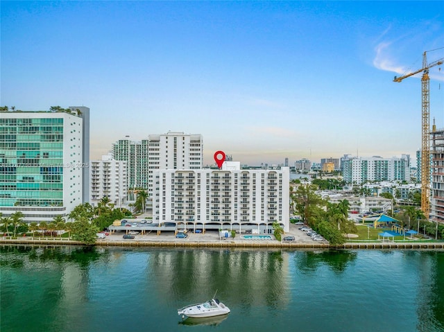 exterior space with a city view and a water view