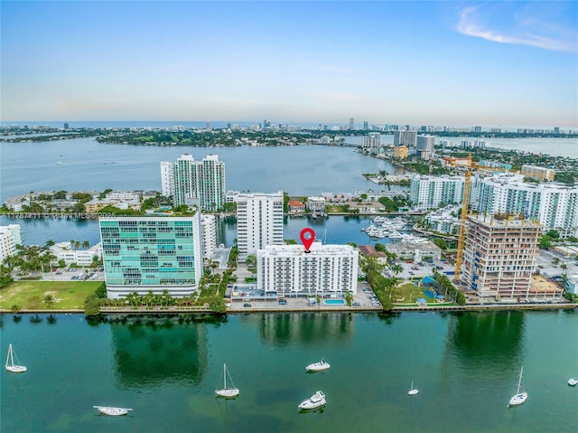 drone / aerial view featuring a view of city and a water view