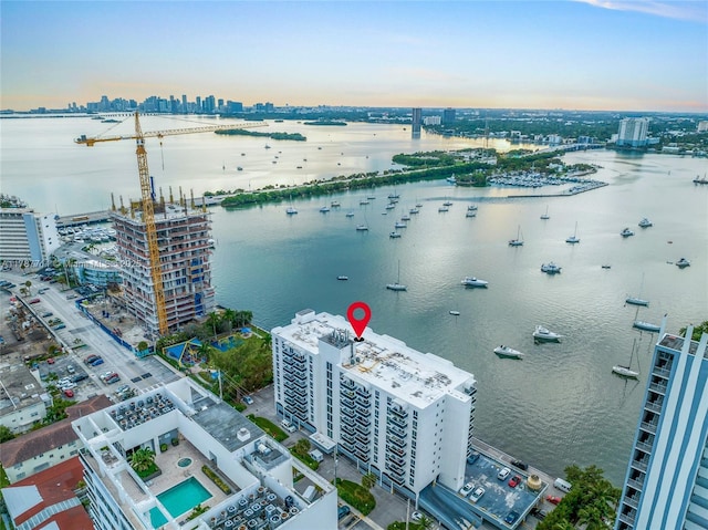 birds eye view of property featuring a city view and a water view