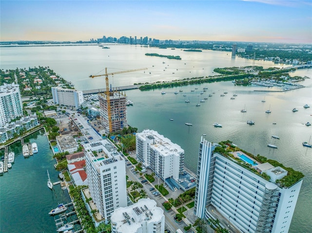 birds eye view of property featuring a view of city and a water view