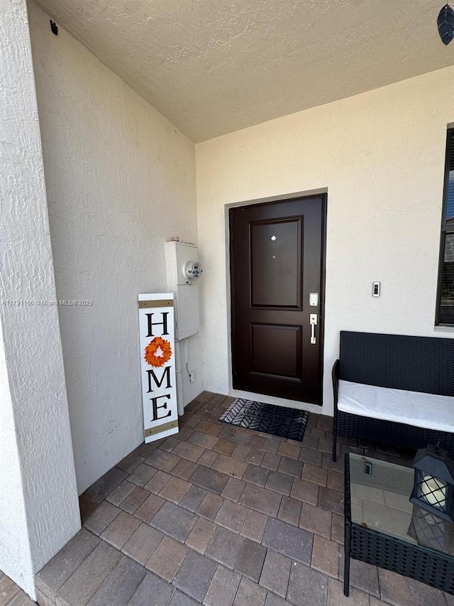property entrance featuring stucco siding