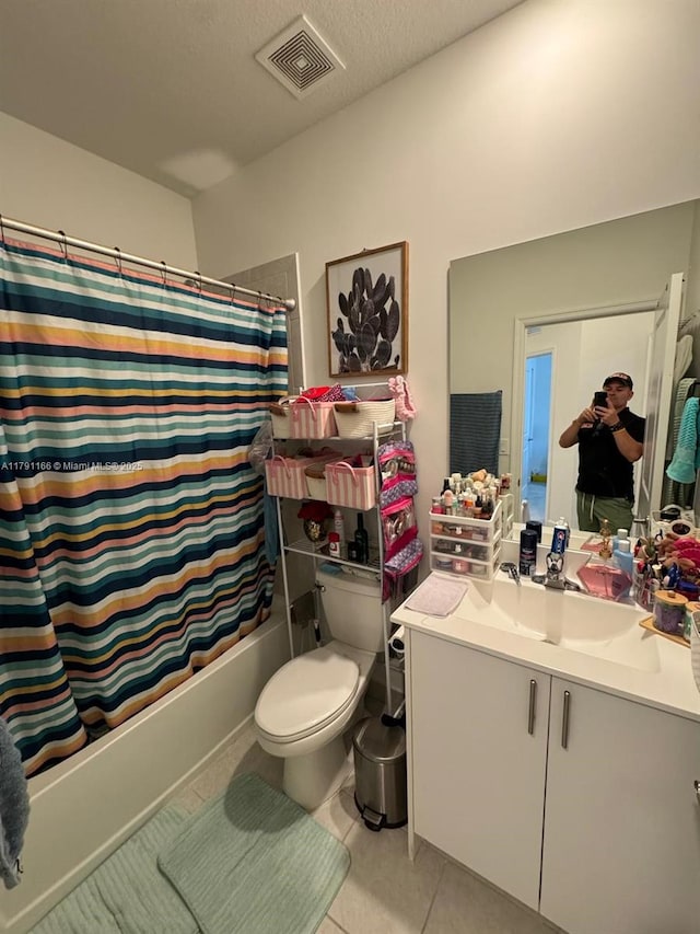 full bathroom with tile patterned flooring, shower / bath combo with shower curtain, toilet, vanity, and visible vents