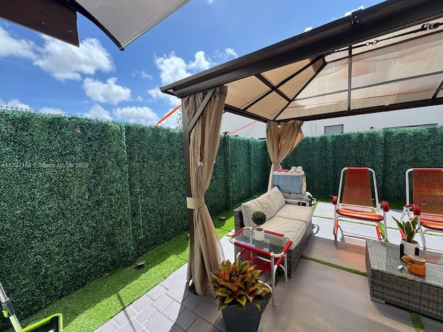 view of patio featuring a gazebo and a fenced backyard