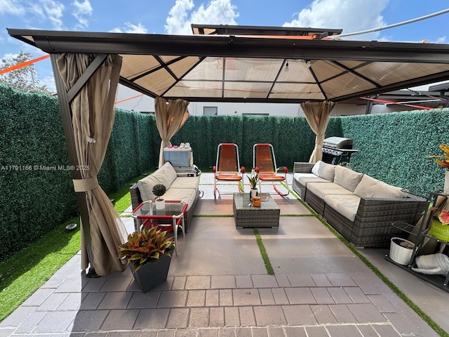 view of patio featuring an outdoor hangout area, area for grilling, a gazebo, and a fenced backyard