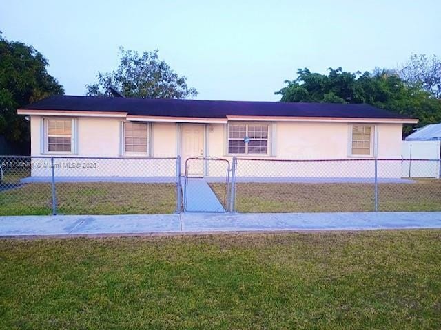 single story home with a fenced front yard and a front yard