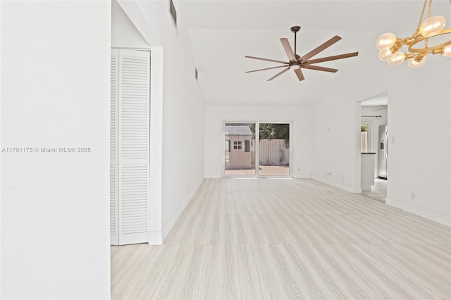 18982 Cloud Lake Cir, Boca Raton, FL 33496 - unfurnished living room with visible vents, baseboards, vaulted ceiling, and ceiling fan with notable chandelier