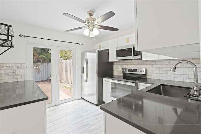 18982 Cloud Lake Cir, Boca Raton, FL 33496 - kitchen with a sink, appliances with stainless steel finishes, tasteful backsplash, and dark countertops