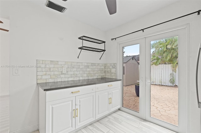 18982 Cloud Lake Cir, Boca Raton, FL 33496 - interior space featuring dark countertops, french doors, a ceiling fan, decorative backsplash, and visible vents