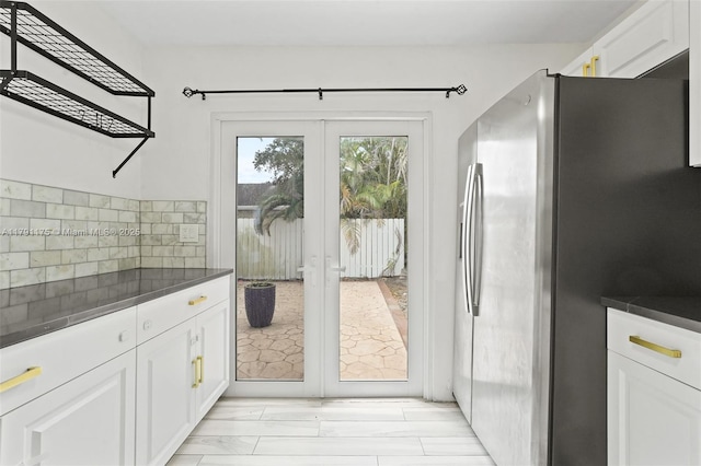 18982 Cloud Lake Cir, Boca Raton, FL 33496 - kitchen featuring stainless steel fridge, dark countertops, white cabinets, and french doors