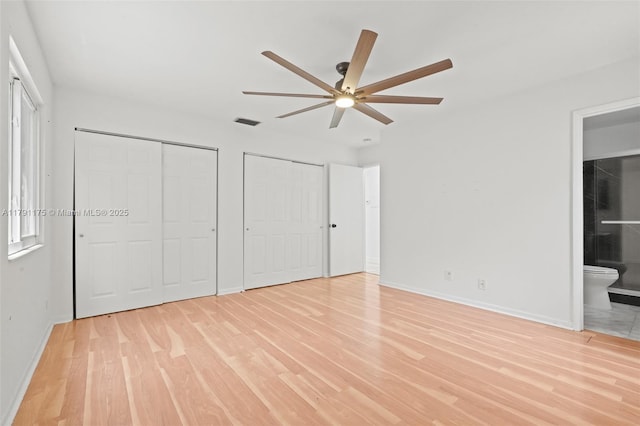 18982 Cloud Lake Cir, Boca Raton, FL 33496 - unfurnished bedroom with two closets, baseboards, visible vents, and light wood-type flooring