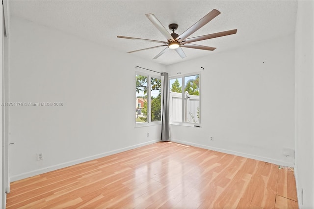 18982 Cloud Lake Cir, Boca Raton, FL 33496 - empty room featuring a textured ceiling, baseboards, a ceiling fan, and wood finished floors