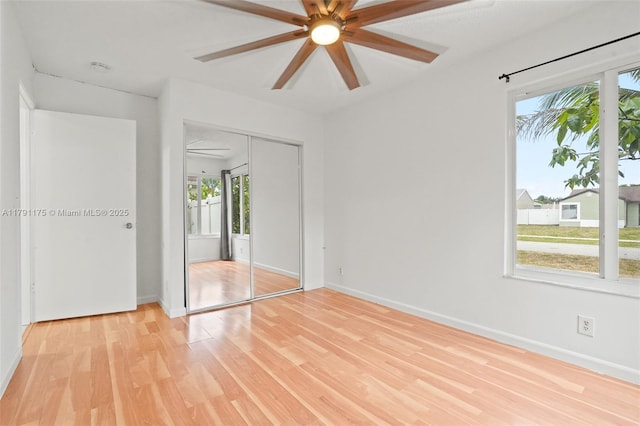 18982 Cloud Lake Cir, Boca Raton, FL 33496 - unfurnished bedroom with a ceiling fan, baseboards, light wood-style flooring, and a closet