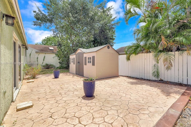 18982 Cloud Lake Cir, Boca Raton, FL 33496 - view of patio featuring an outdoor structure, a shed, and fence