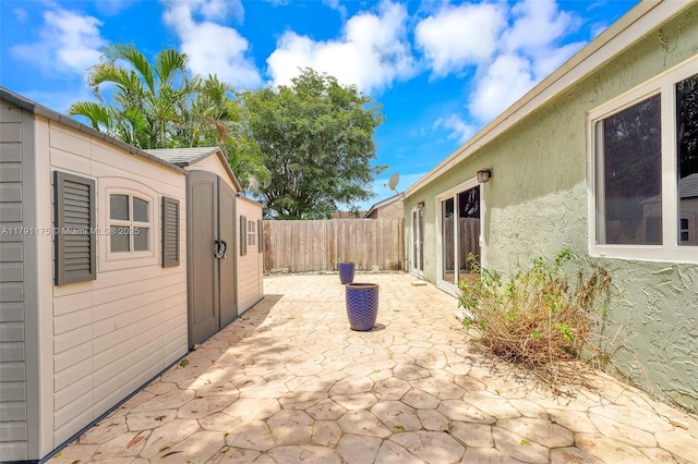 18982 Cloud Lake Cir, Boca Raton, FL 33496 - view of patio / terrace featuring a fenced backyard and an outbuilding