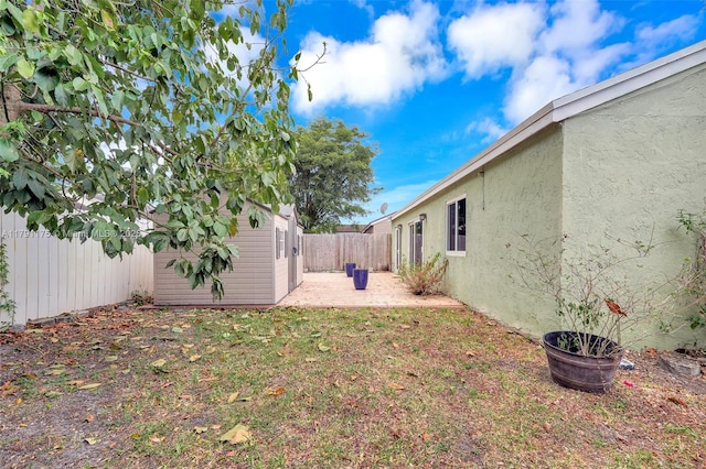 18982 Cloud Lake Cir, Boca Raton, FL 33496 - view of yard with a fenced backyard, a patio area, and an outbuilding