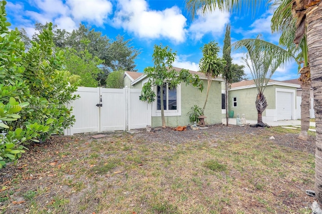 18982 Cloud Lake Cir, Boca Raton, FL 33496 - view of front facade featuring fence, a gate, and stucco siding