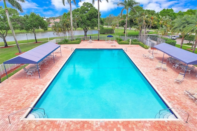 18982 Cloud Lake Cir, Boca Raton, FL 33496 - pool featuring fence, a patio, and a water view