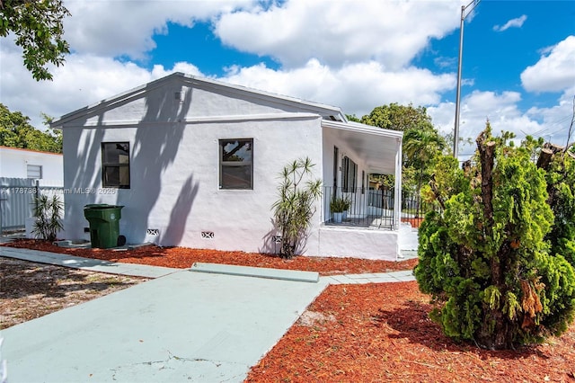 1710 E 6th Ave, Hialeah, FL 33010 - back of house featuring stucco siding, fence, and crawl space