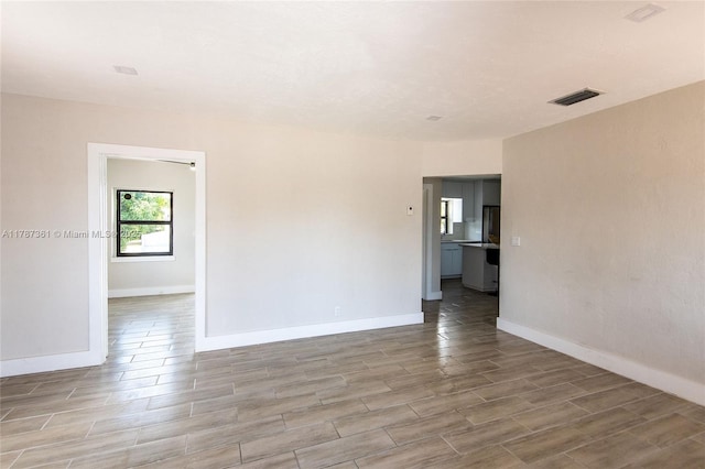 1710 E 6th Ave, Hialeah, FL 33010 - spare room with light wood-type flooring and baseboards