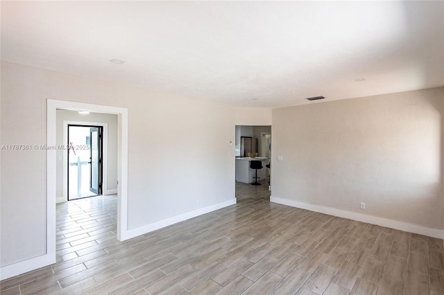 1710 E 6th Ave, Hialeah, FL 33010 - empty room with light wood finished floors and baseboards