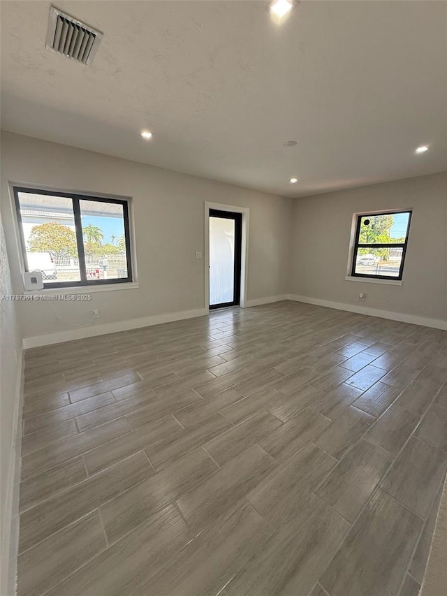 1710 E 6th Ave, Hialeah, FL 33010 - unfurnished room featuring baseboards, recessed lighting, and wood tiled floors