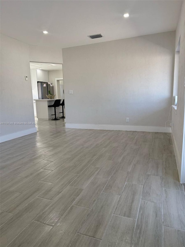 1710 E 6th Ave, Hialeah, FL 33010 - unfurnished room featuring light wood-style flooring, baseboards, and recessed lighting