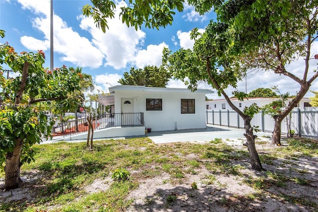 1710 E 6th Ave, Hialeah, FL 33010 - rear view of property featuring fence, stucco siding, and a patio area